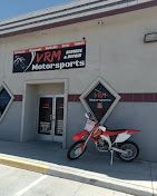 VRM Motorsports storefront with a red dirt bike parked outside.